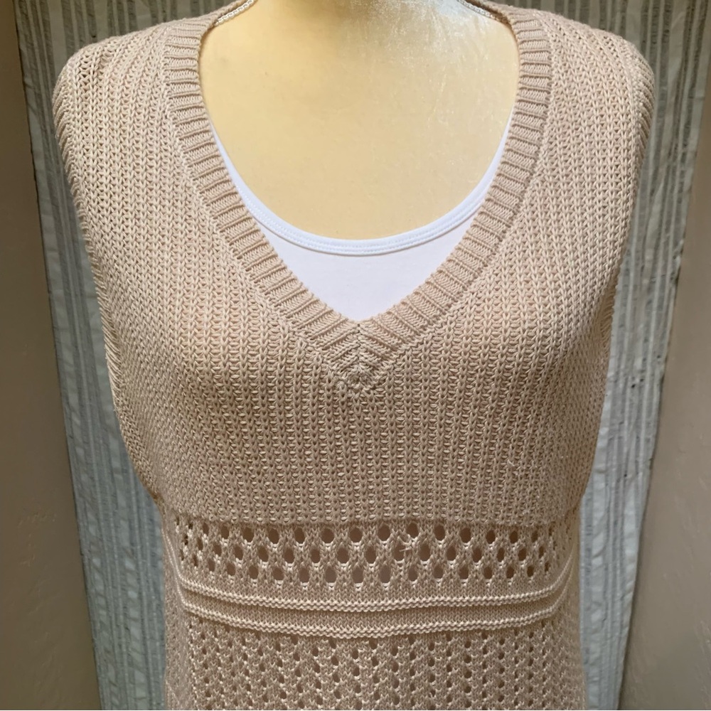 Tan knit vest, sleeveless sweater.